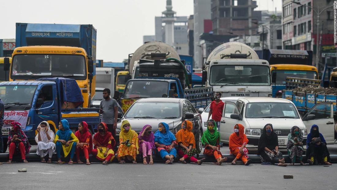 Workers from the garment sector in Dhaka, Bangladesh, block a road during a protest demanding payment of unpaid wages.