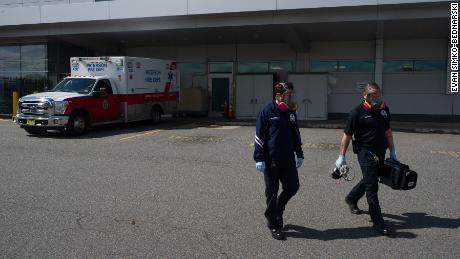Storzillo and Incorvaia head back to their truck after bringing a probable Covid-19 patient to the ER.