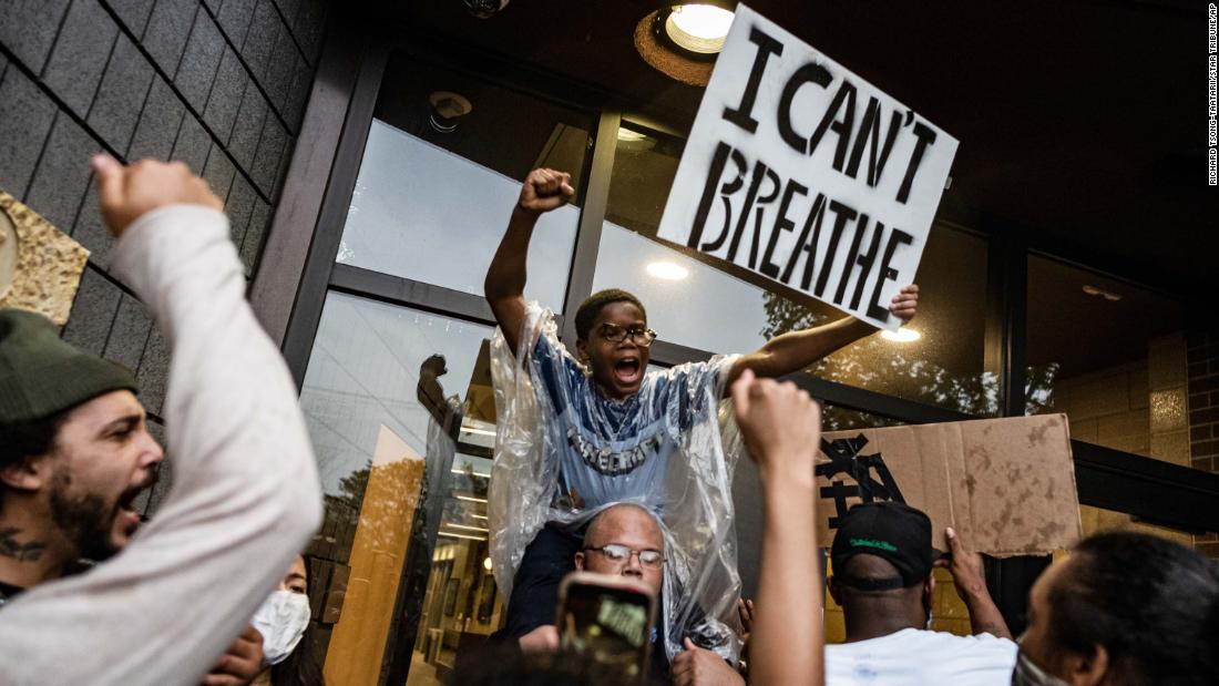 People gather outside a police precinct during demonstrations in Minneapolis on May 26.
