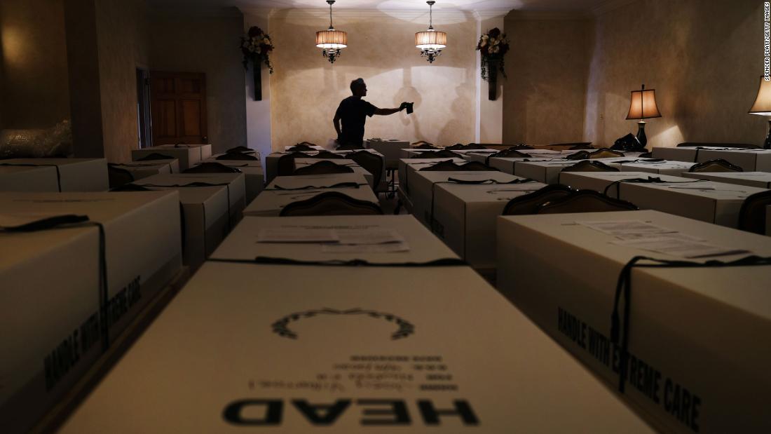 Omar Rodriguez organizes caskets at the Gerard Neufeld Funeral Home in New York on April 22. The funeral home in Queens has been overwhelmed by the pandemic.