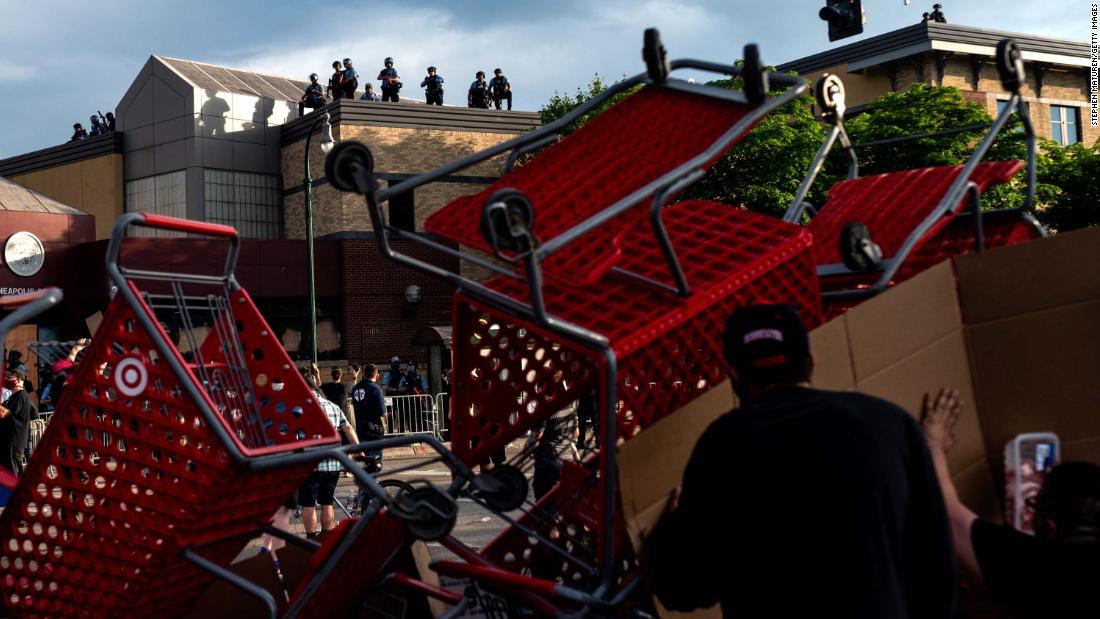 Protesters use shopping carts as a barricade as they confront police near a Minneapolis police precinct on May 27.