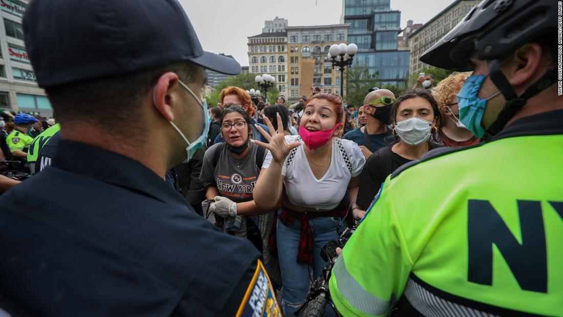 Protesters speak to police officers during a demonstration in New York City on May 28.