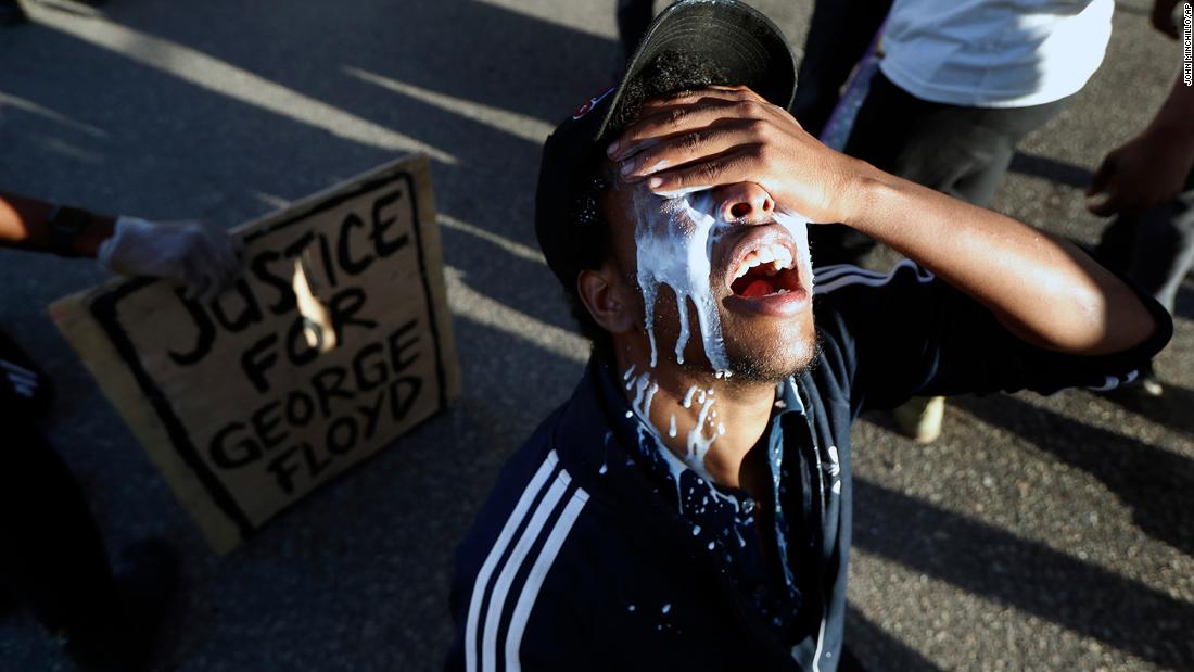 A protester in Minneapolis douses himself with milk on May 29.