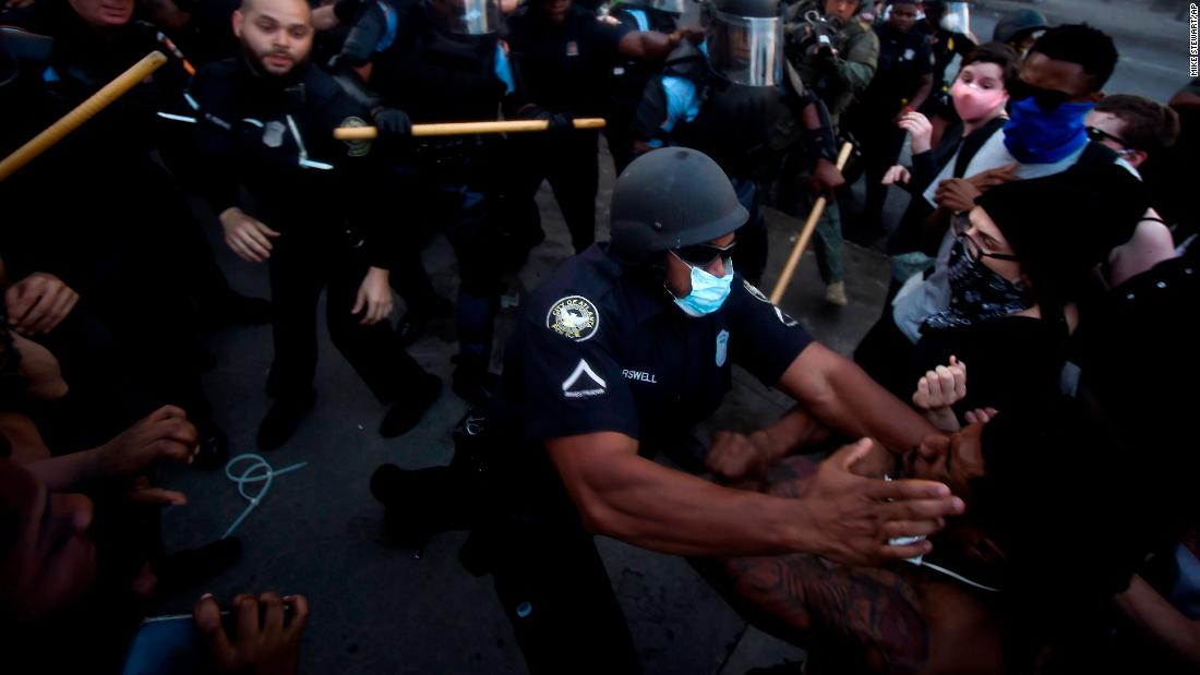 Police officers and protesters clash near the CNN Center in Atlanta on May 29.