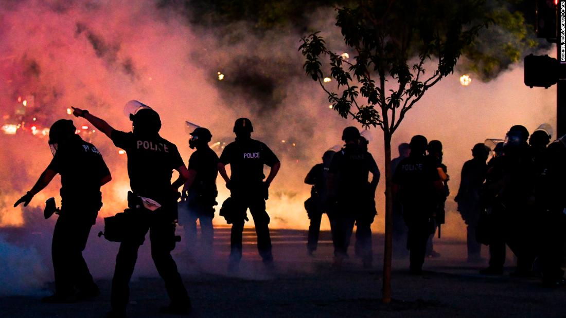 Police officers fire tear gas at protesters in Denver on May 29.