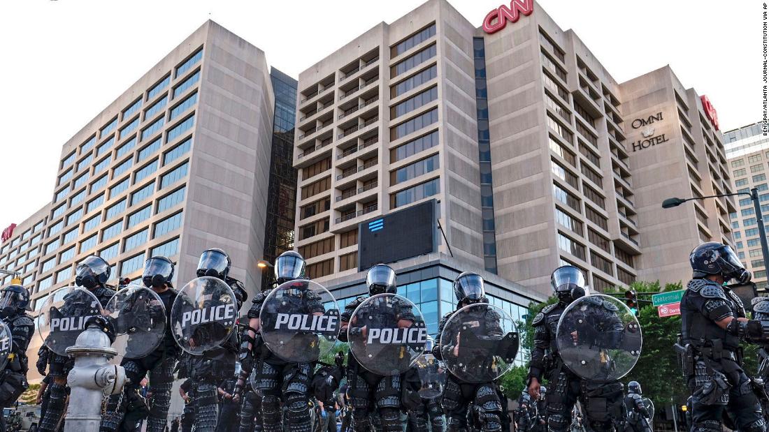 Police stand guard near the CNN Center and Centennial Olympic Park as protests continued in Atlanta on May 30.