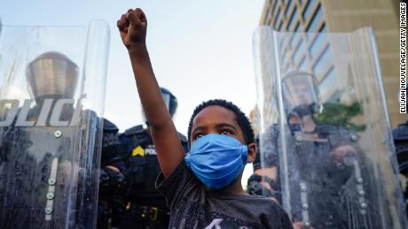 A young boy raises his fist during a demonstration on May 31 in Atlanta