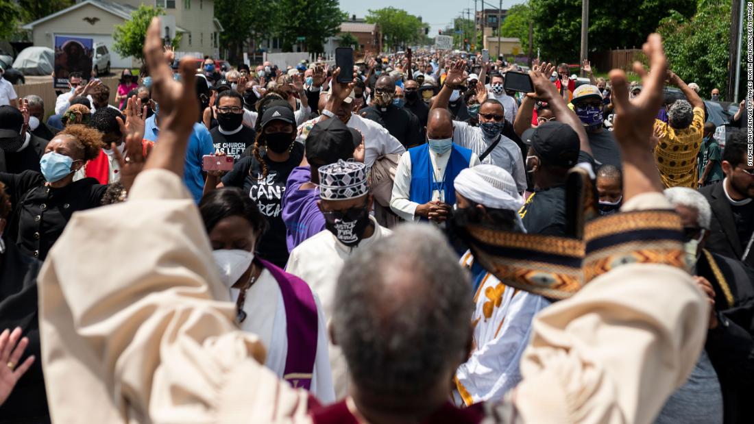 A group of clergy members stops and prays during a march to a George Floyd memorial in Minneapolis on June 2.
