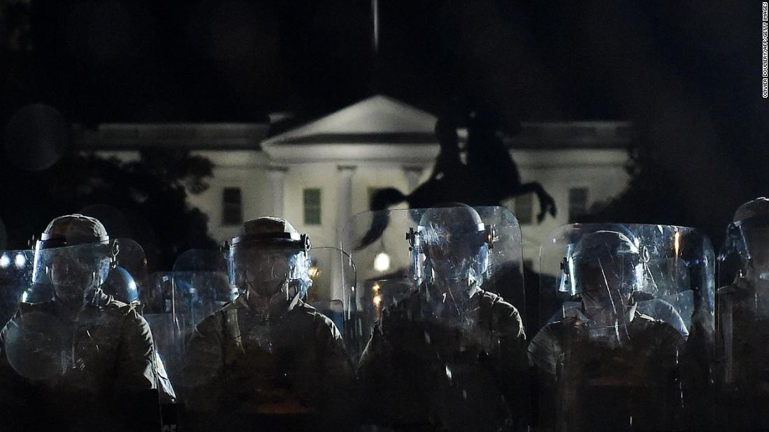 Police officers hold a perimeter June 2 behind a metal fence that was recently erected in front of the White House.