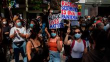 In Madrid, a protester warns that &quot;Systemic racism is a pandemic.&quot; 