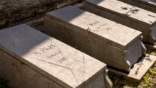 The graves of seven Congolese people brought to Belgium to be put on display in an &quot;African village&quot; in Brussels, which has been described as a &quot;human zoo.&quot;