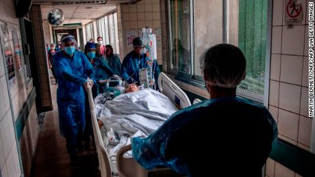 Nurses move a Covid-19 patient to a critical care unit at a hospital in Santiago, Chile, on June 24, 2020. 