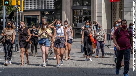 People wear face masks in Barcelona, Spain, where those who don&#39;t do so in a public space face a 100 euro fine.