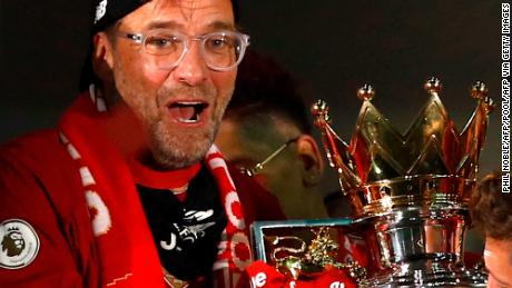 Jurgen Klopp poses with the Premier League trophy.