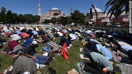 Men take part in Friday prayers outside Hagia Sophia in Istanbul on July 24, 2020.