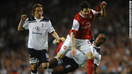 Playing for Arsenal, Fabregas is tackled by Tom Huddlestone of Spurs during the Premier League match between Tottenham Hotspur and Arsenal at White Hart Lane on April 20, 2011 in London, England.