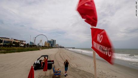 No swimming flags fly over a lifeguard stand in downtown Myrtle Beach, South Carolina on Monday, August 3, 2021.