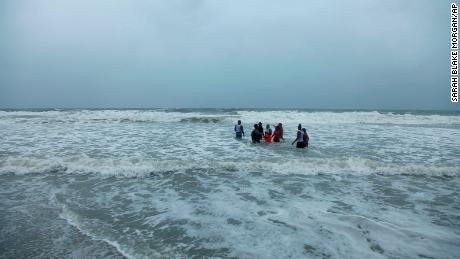 Kerra Houser and her family swim in the North Myrtle Beach, South Carolina surf on Monday, August 3, 2021. 