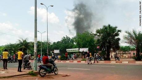 Smoke rises from the residence of Mali's finance minister Kassim Tapo in Bamako on Aug. 18, 2021. 