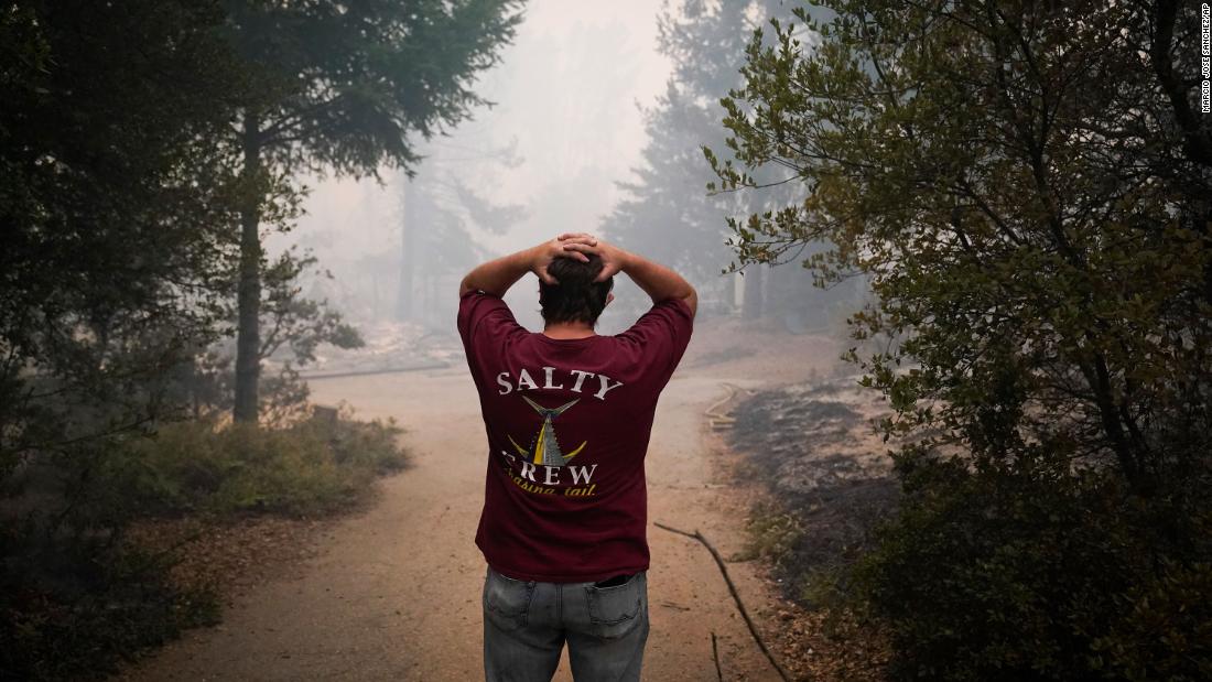 Peter Koleckar reacts after seeing multiple homes burned in his neighborhood in Bonny Doon, California, on August 20.