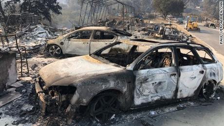 The remains of charred vehicles rest Saturday in a neighborhood near Lake Berryessa in Northern California&#39;s Napa County.