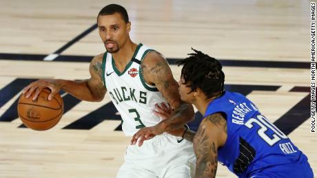 Bucks&#39; George Hill (left) dribbles against the Orlando Magic in the NBA playoffs.
