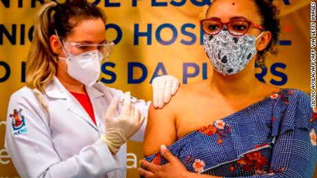 A Brazilian volunteer receives a coronavirus vaccine produced by Chinese company Sinovac Biotech at the Sao Lucas Hospital in Porto Alegre, southern Brazil on August 8.