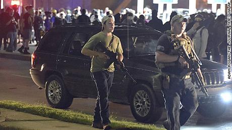Kyle Rittenhouse, left, with backwards cap, is shown Tuesday, the night of the shooting, in Kenosha, Wisconsin. 