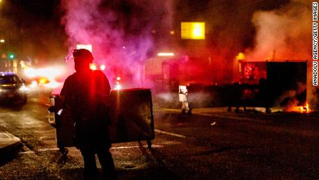 People protesting police brutality spray graffiti and start fires at the Portland Police Union building on Friday. 