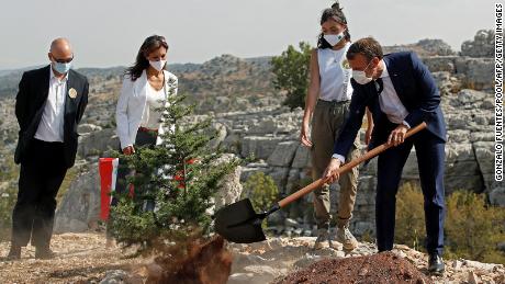 French President Emmanuel Macron plants a cedar tree in Jaj Cedars Reserve Forest, to mark Lebanon&#39;s centenary on September 1.
