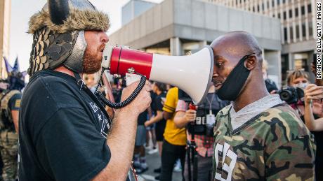 Dueling demonstrators argue outside Louisville Metro Hall on Saturday, September 5, 2020. 
