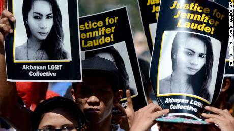 Supporters of the late Jennifer Laude hold up her image during a protest near a Philippine court in Olongapo, north of Manila on February 23, 2015.