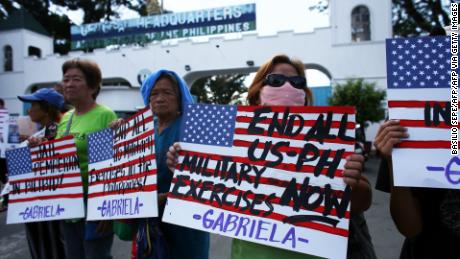 Demonstrators hold placards during a protest in front of the Department of National Defense in Manila on February 21, 2020. Members of the Gabriela Alliance for Women called for the immediate transfer of of US Marine Joseph Scott Pemberton to the National Bilibid Prison.