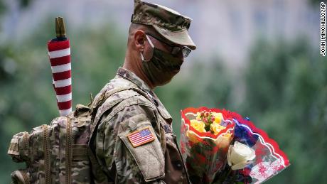 US Army Sgt. Edwin Morales leaves  flowers for fallen FDNY firefighter Ruben D. Correa at the National September 11 Memorial &アンプ; Museum.