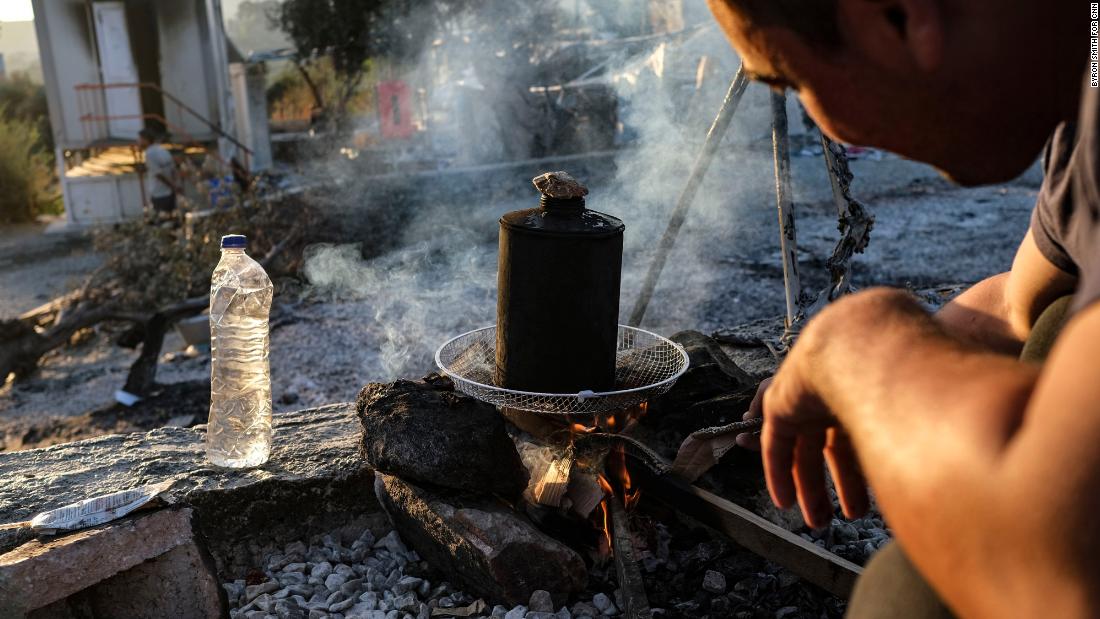 An Afghan migrant starts a fire for his family&#39;s morning tea on September 11.