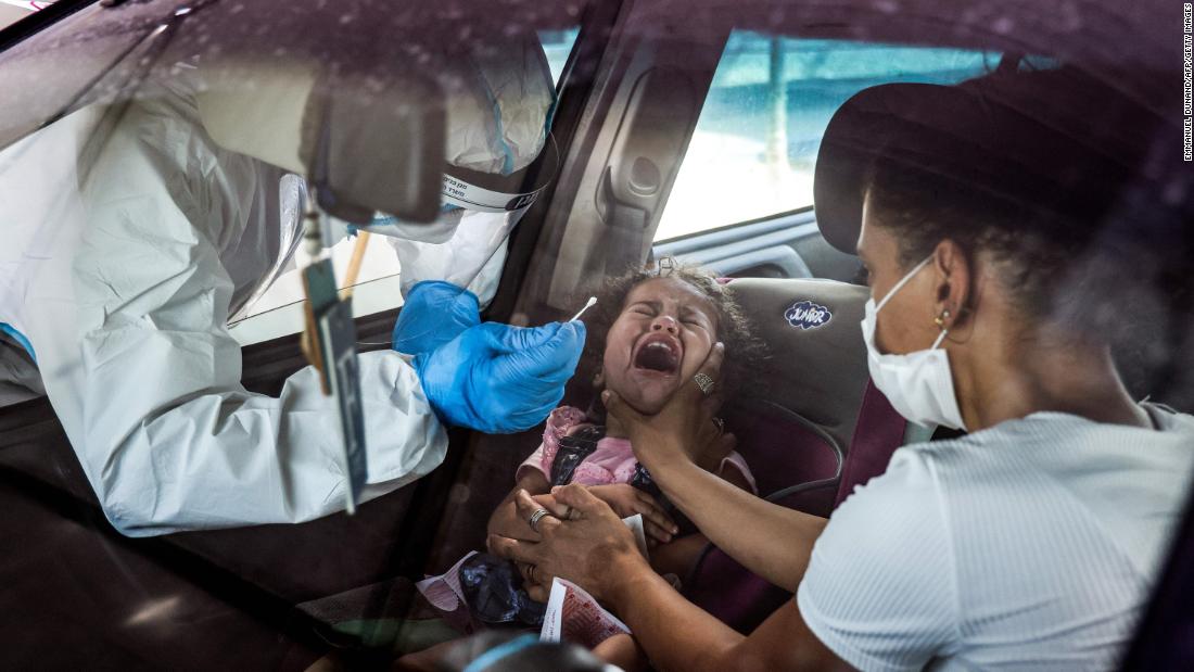 A girl cries as she is tested for Covid-19 at a drive-thru testing station in East Jerusalem on September 6.