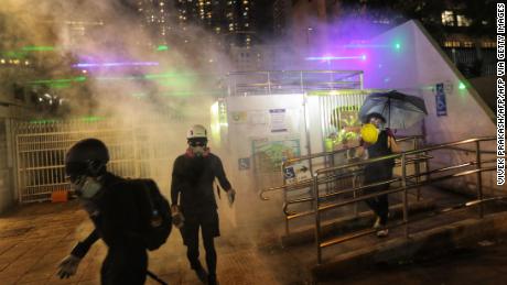 Police fire tear gas to disperse protesters gathered outside a police station in the Tsim Sha Tsui district after taking part in a rally against a controversial extradition bill in Hong Kong on August 10, 2019.