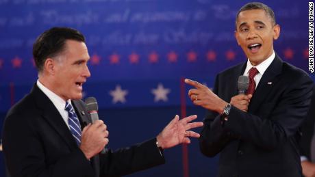 Republican presidential candidate Mitt Romney  and US President Barack Obama talk over each other as they answer questions during a town hall style debate at Hofstra University October 16, 2012 in Hempstead, New York. 