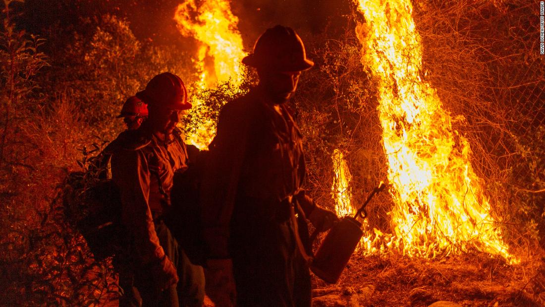 Mill Creek Hotshots set a back burn to protect homes from the Bobcat Fire on Sunday, September 13 in Arcadia, California. 