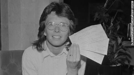 King holds three checks following her win at Wimbledon in 1973.
