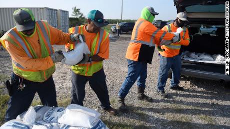 Corpus Christi city workers load free sandbags for residents ahead of Tropical Storm Beta.