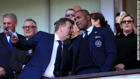 Ferdinand (right) looks on during a Championship match between Ipswich and QPR in 2018.