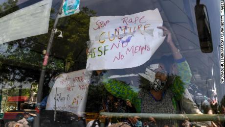 Protestors holding signs from a bus during a demonstration in New Delhi, India, on September 30, after the death of a 19-year-old woman who was allegedly gang raped. 