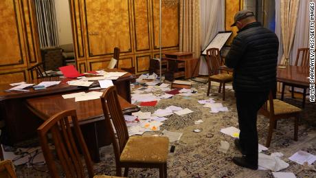 Documents are scattered across a room in the White House after it was ransacked by protesters. 