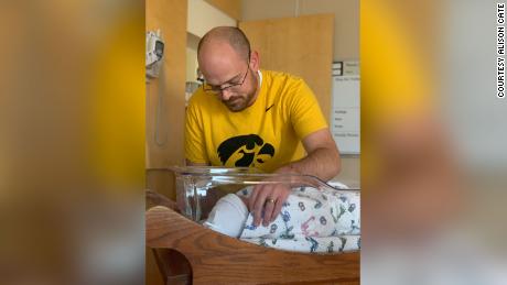 Jimmy Cate, shown with newborn Beric, was back at work one week after his son&#39;s birth.
