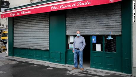 Cesar, from Portugal, stands in front of his bar, in Paris, on October 6, 2020 after all bars in the city were closed under new Covid-19 restrictions.
