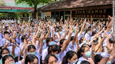 Students make the three-fingered salute at Samsen school to demand for less strict school rules, more tolerance and respect during a protest in Bangkok on October 2, 2020.