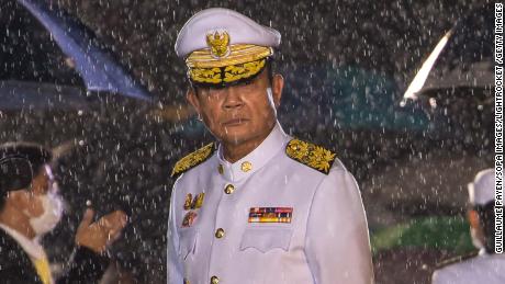 Prime Minister Prayut Chan-o-cha is seen amidst a heavy downpour during an event marking the death of late Thai King Bhumibol Adulyadej on October 13.