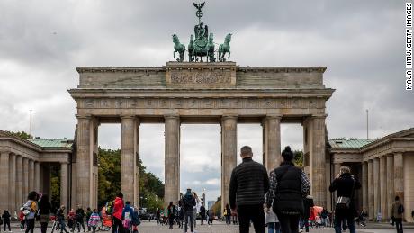 Tourists walk at the Brandenburg Gate in Berlin, Germany on October 12, as gatherings were limited to 10 people and an 11 p.m. curfew imposed in several regions.