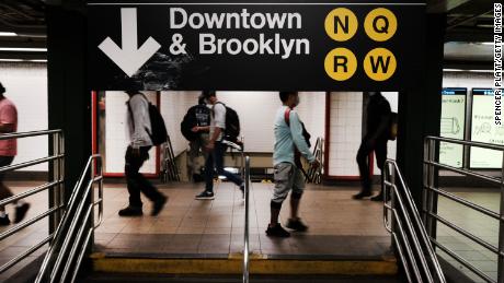People walk through a nearly empty Manhattan subway station on August 26, 2020 in New York City. 